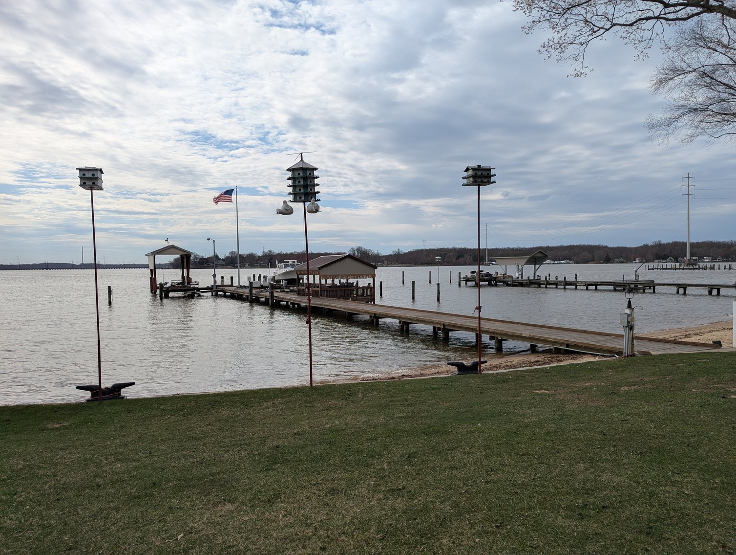 Image for LARGE WATERFRONT PROPERTY/ 2-STORY CONTEMP. HOME W/ ATT. 2-CAR GARAGE & 1-BR COTTAGE HOME/(4) PARCELS TOTALING 3.35 +/- AC SOLD IN THE ENTIRETY/ 155' FT FRONTAGE ON BUSH RIVER W SANDY BEACH/ LARGE DOCK W/ (10) +/- BOAT SLIPS, TIKI BAR & MORE!