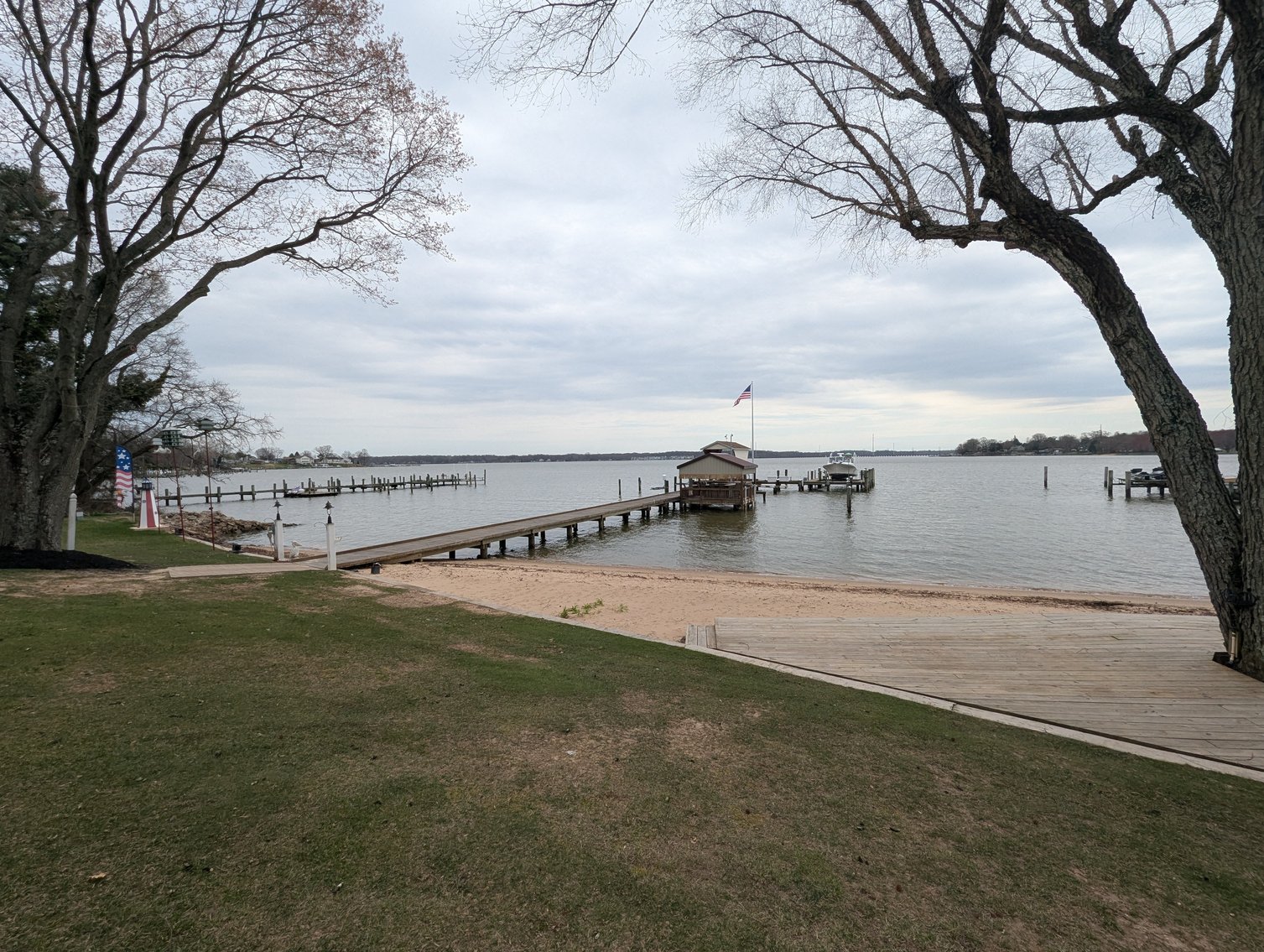 Image for LARGE WATERFRONT PROPERTY/ 2-STORY CONTEMP. HOME W/ ATT. 2-CAR GARAGE & 1-BR COTTAGE HOME/(4) PARCELS TOTALING 3.35 +/- AC SOLD IN THE ENTIRETY/ 155' FT FRONTAGE ON BUSH RIVER W SANDY BEACH/ LARGE DOCK W/ (10) +/- BOAT SLIPS, TIKI BAR & MORE!