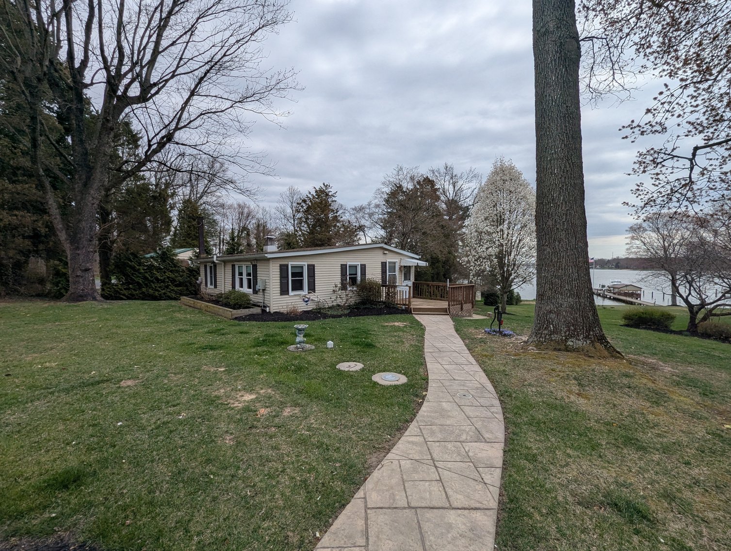Image for LARGE WATERFRONT PROPERTY/ 2-STORY CONTEMP. HOME W/ ATT. 2-CAR GARAGE & 1-BR COTTAGE HOME/(4) PARCELS TOTALING 3.35 +/- AC SOLD IN THE ENTIRETY/ 155' FT FRONTAGE ON BUSH RIVER W SANDY BEACH/ LARGE DOCK W/ (10) +/- BOAT SLIPS, TIKI BAR & MORE!
