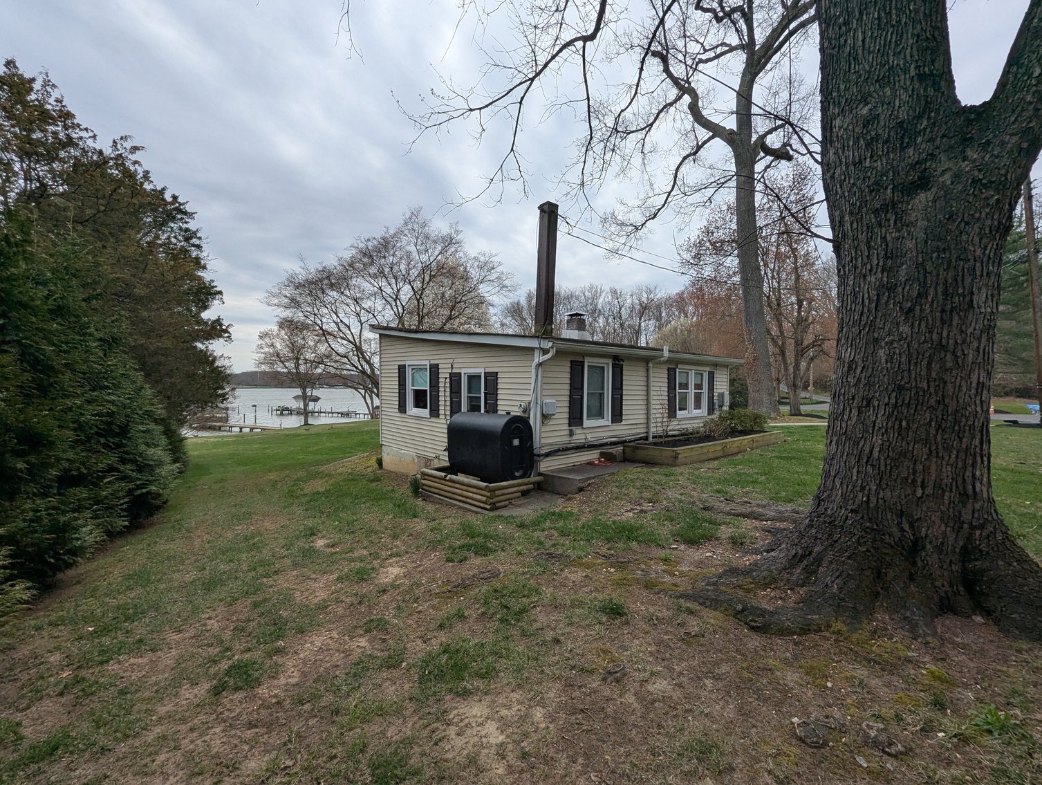 Image for LARGE WATERFRONT PROPERTY/ 2-STORY CONTEMP. HOME W/ ATT. 2-CAR GARAGE & 1-BR COTTAGE HOME/(4) PARCELS TOTALING 3.35 +/- AC SOLD IN THE ENTIRETY/ 155' FT FRONTAGE ON BUSH RIVER W SANDY BEACH/ LARGE DOCK W/ (10) +/- BOAT SLIPS, TIKI BAR & MORE!